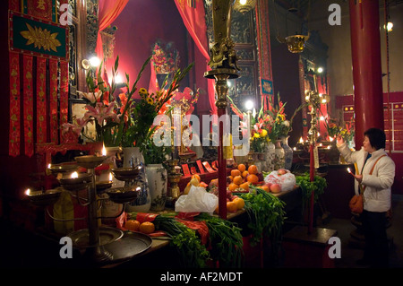 Femme chinoise d'âge moyen à l'adoration du Temple Man Mo à Hong Kong Banque D'Images