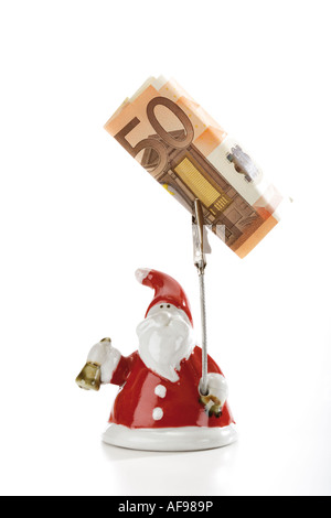 Santa Claus Figurine holding euro note Banque D'Images