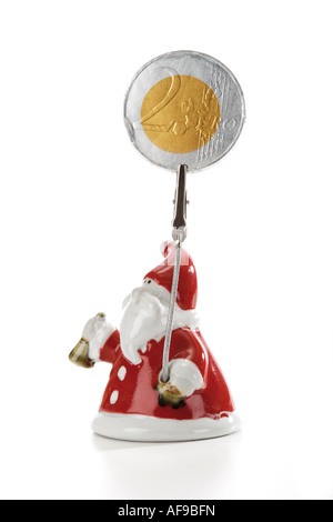 Santa Claus Figurine holding euro coin Banque D'Images