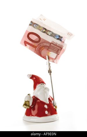 Santa Claus Figurine holding euro note Banque D'Images