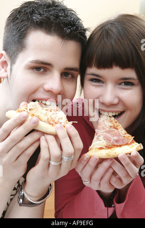 Woman is eating fast food pizza. Banque D'Images