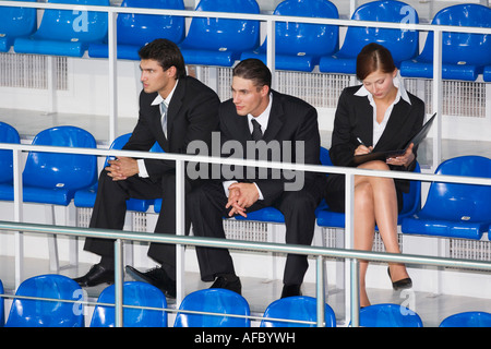 Businesspeople sitting sur tribune Banque D'Images