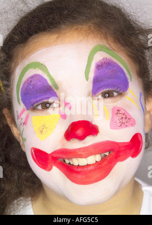 Jeune fille avec un visage heureux peint comme clown Banque D'Images