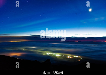 Le soleil se lève et la lune suspendue dans le ciel bleu au-dessus des nuages en vue du Japon s san dans l'Iwate préfecture d'Iwate Banque D'Images