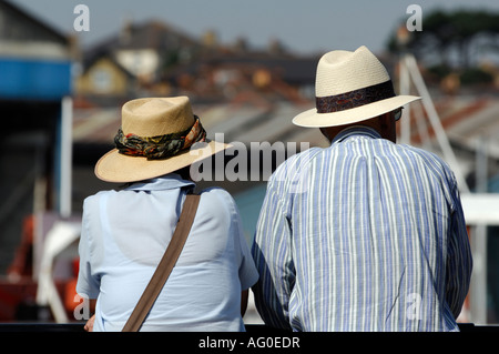 Un vieux couple de personnes âgées s'appuyant sur un mur donnant sur la mer au cours de la semaine de Cowes sur l'île de Wight Banque D'Images