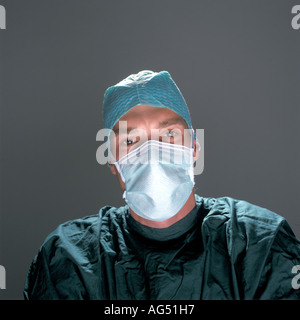 Jeune médecin chirurgien portant masque et théâtre de fonctionnement vert gown Banque D'Images