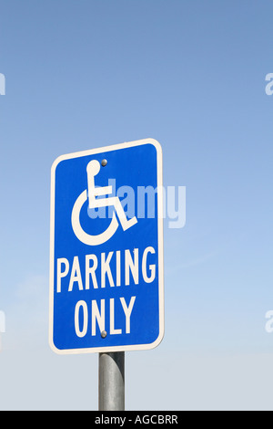 Handicap parking sign against blue sky background Banque D'Images