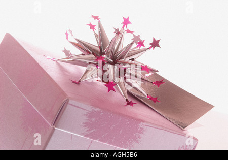 Cadeau de Noël en rose en forme d'étoile avec boîte aluminium bow on top against white background Banque D'Images