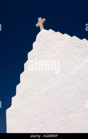 Le mur peint en blanc et petite croix sur le haut de la petite église de Agios Nikolakis sur Mykonos, Grèce. Banque D'Images