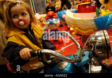 Petite fille jouant dans un carrousel Banque D'Images