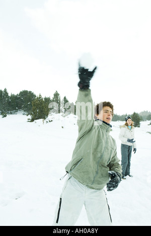 Teenage boy throwing snowball, blurred motion Banque D'Images