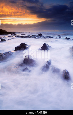 La marée montante lave sur les rochers au crépuscule à Westward Ho ! Dans le Devon, Angleterre Banque D'Images