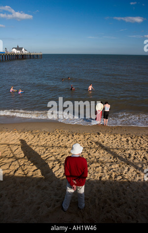 Un homme se tient sur la plage face à la mer à Suffolk Southwold Banque D'Images