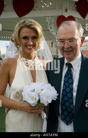 Bride standing with a senior man and smiling Banque D'Images