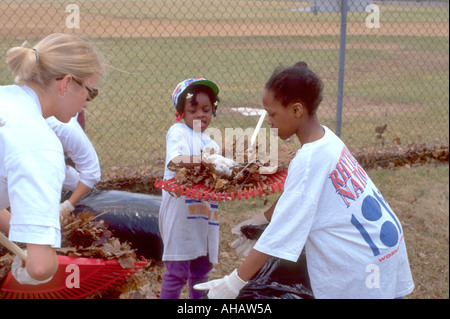 Les jeunes et l'âge 6 et 8 Mentor et 21 feuilles d'ensachage au champ Express Jeunes Dunning. nettoyage de printemps St Paul Minnesota USA Banque D'Images