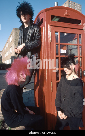 Punk rock original posing in front of red phone box Banque D'Images