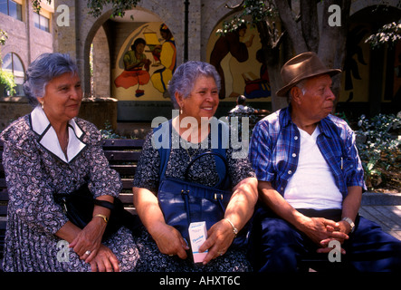 3 Trois Mexicains, la femme mexicaine et l'homme amis assis sur le banc de parc en Plaza Tapatia à Guadalajara dans l'État de Jalisco au Mexique Banque D'Images
