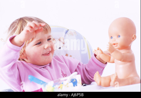 Tout-petit enfant 0 5 peau claire dodus juste juste aux cheveux bouclés blonds babygro asseoir l'appétit alimentaire spoon Banque D'Images