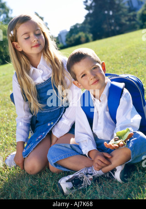 Enfants Enfant Garçon fille blonde cheveux long frère sœur écolier sac d'écolière chemise blanche Banque D'Images