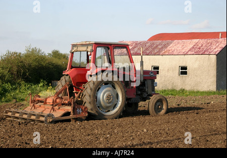 Petit vieux tracteur rouge en champ labouré, Moira, comté de Down, Irlande du Nord Banque D'Images