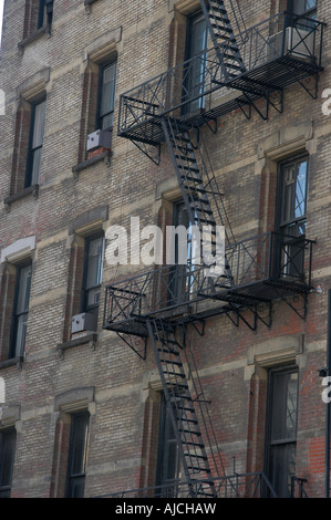 Le feu s'échapper sur le côté d'un bloc appartement New York Banque D'Images