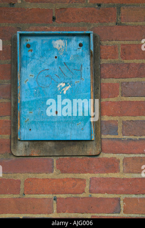 Tableau d'affichage en bois bleu avec châssis 'Gilly' écrit dessus. Attaché à un mur de brique à la gare routière de Derby Banque D'Images
