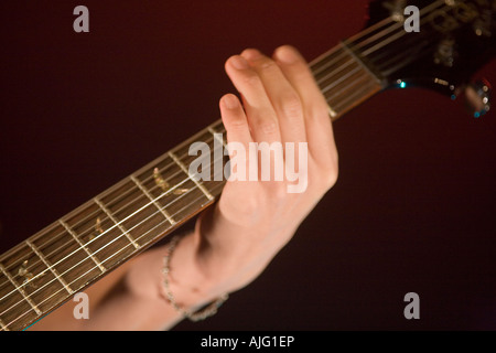 Jeune homme jouant de la guitare électrique sur scène Banque D'Images