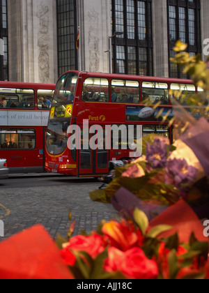 Soirée le trafic et de décrochage de fleurs sur Kensington High Street Royal Borough of Kensington Chelsea London England UK Banque D'Images