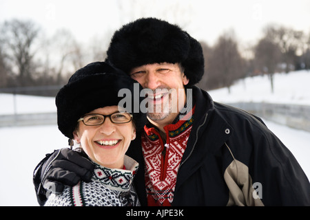 Portrait of Caucasian middle aged man and woman wearing black winter hats smiling at viewer Banque D'Images
