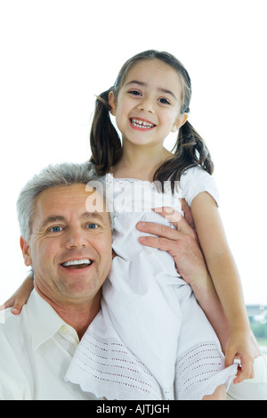 Man holding up little girl, portrait Banque D'Images