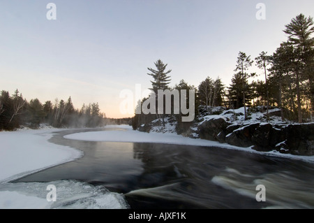 De l'eau libre au-dessus de la rivière Wanapitei rapids avant l'aube sur un froid matin d'hiver, le Grand Sudbury, Ontario, Canada Banque D'Images