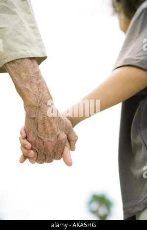Senior woman and boy holding hands, portrait, close-up Banque D'Images