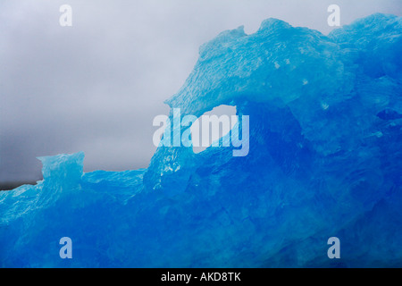 Close up of belle classique bleu iceberg que l'on trouve généralement près de Narsaq contre ciel gris pluvieux sur la côte ouest du Groenland Banque D'Images