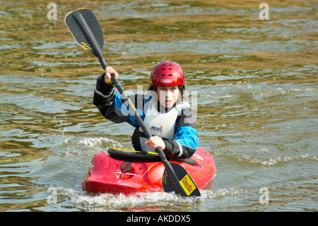 Jeune enfant caucasien dans un kayak, sur une rivière. Banque D'Images