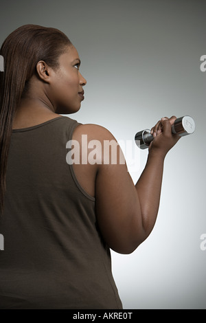 Woman with dumbbell Banque D'Images