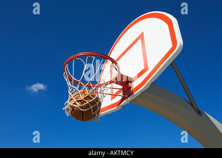 Le basket-ball en passant par hoop Banque D'Images