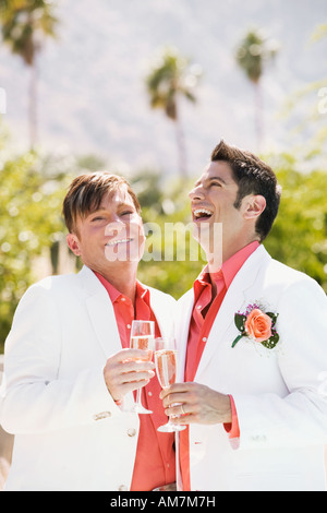 Young gay couple toasting with champagne Banque D'Images