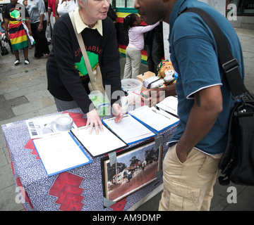 Signature pétition contre la démocratie du Zimbabwe Mugabe veillée Londres Banque D'Images