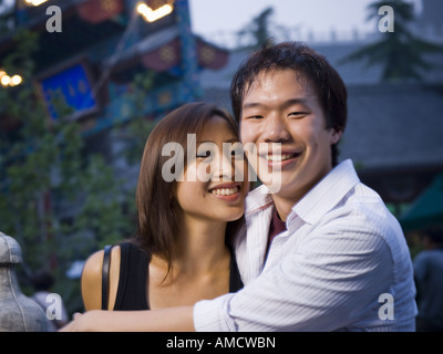 Couple embracing and smiling outdoors Banque D'Images