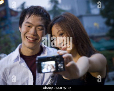 Woman smiling outdoors et avec l'appareil photo Banque D'Images
