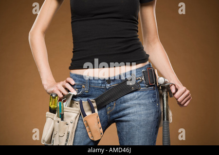 Mid section view of woman with tool belt Banque D'Images