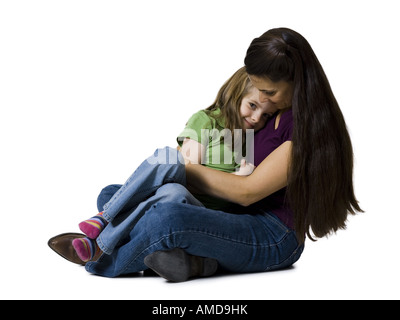 Woman sitting cross legged with girl Banque D'Images