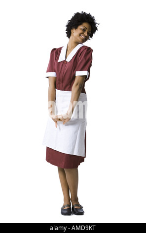 Woman smiling in uniforme maid Banque D'Images