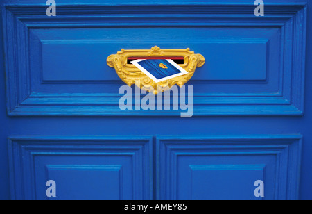 De montage photo de carte postale dans la boîte aux lettres jaune jaune sur bleu identiques letterbox porte avant Banque D'Images