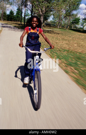 Girl Riding Bicycle on Path Banque D'Images