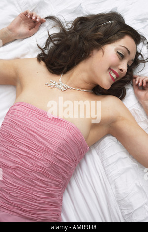 Woman Lying on Bed Banque D'Images