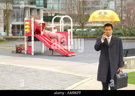 Businessman With Umbrella In Enfant Jeux pour Enfants Banque D'Images