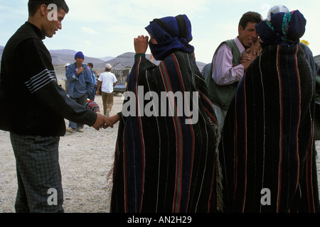 Cour deux jeunes hommes hait Haddidou les femmes à l'Imilchil Brides juste le Haut Atlas Maroc Banque D'Images