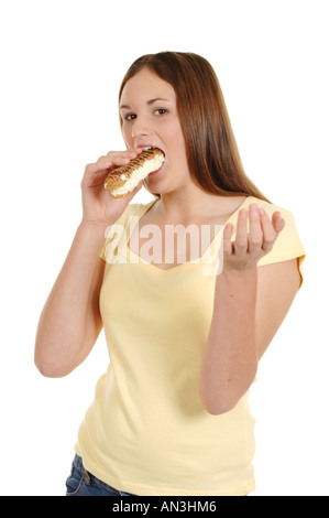 Une adolescente de manger un gâteau à la crème Banque D'Images