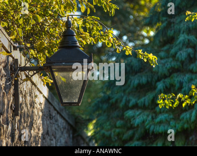 Rue ancienne lampe en fonte sur mur de pierre Banque D'Images